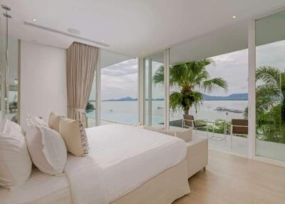 Spacious bedroom with large windows and ocean view