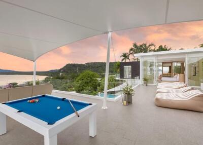 Rooftop terrace with pool table and seating area