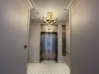 Elevator hallway with chandelier