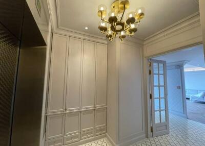 Elegant hallway with chandelier and built-in storage