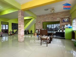 Spacious living room with dining area and staircase.