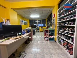 Office space with bright yellow walls and shelves filled with collectibles