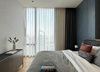 Modern bedroom with floor-to-ceiling window and city view