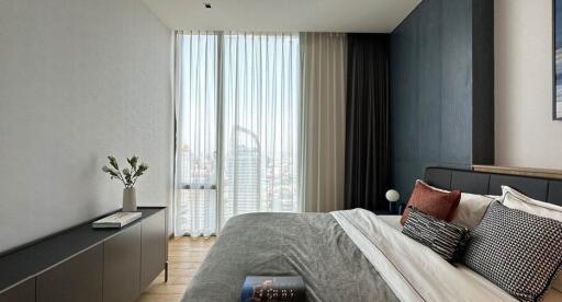 Modern bedroom with floor-to-ceiling window and city view