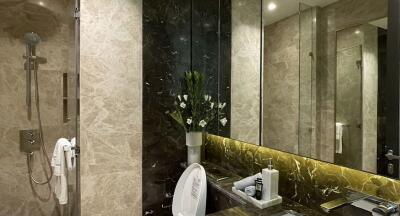 Modern bathroom with marble walls and a glass shower