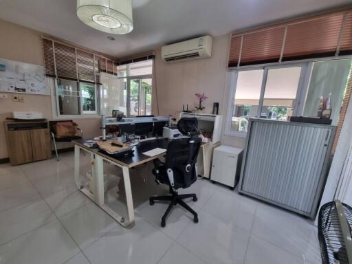 Well-lit office space with desk, chair, and air conditioning