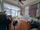 Bright sunroom with ceiling fan and tile flooring