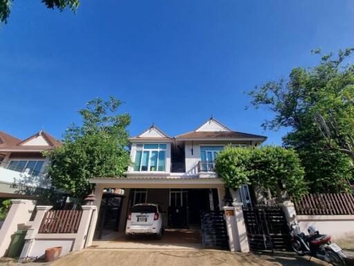 Front view of a modern two-story house with car parked in the driveway