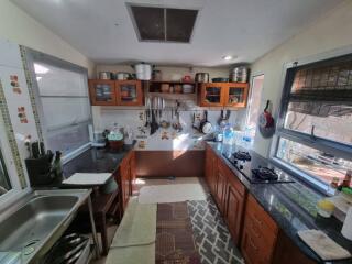 Modern kitchen with wooden cabinets and stainless steel sink