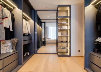 Luxurious walk-in closet with ample storage space, view into a bedroom