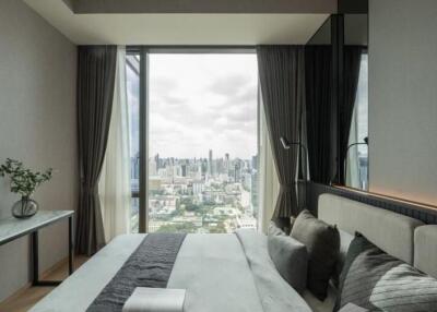 Modern bedroom with a large window showcasing a city view