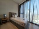 Well-lit bedroom with floor-to-ceiling windows