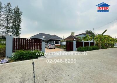 Exterior view of a house with a gated driveway