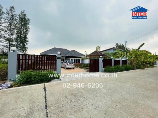 Exterior view of a house with a gated driveway