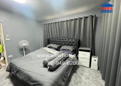Cozy bedroom with double bed and gray curtains