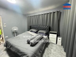 Cozy bedroom with double bed and gray curtains