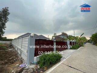 Photo of the exterior of a house with gated entrance