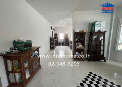 Spacious living area with decorative wooden cabinets and tiled flooring