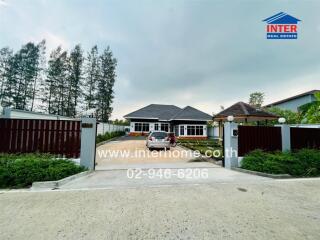 Exterior view of a house with a driveway and gate