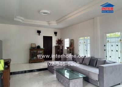 Spacious living room with grey L-shaped sofa and glass coffee table
