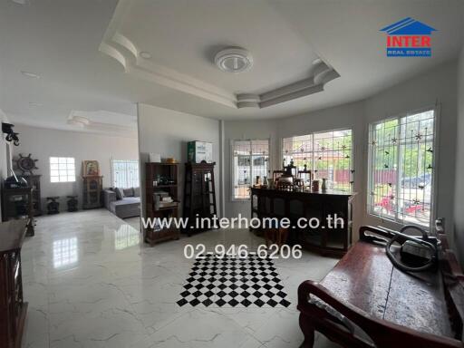 Spacious living room with classic furniture and large windows allowing ample natural light