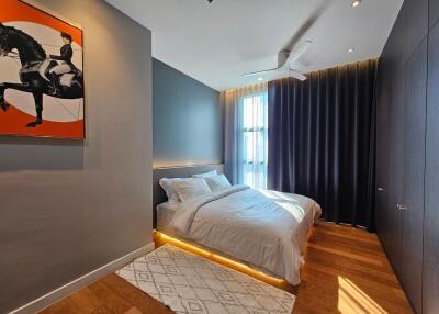 modern bedroom with artwork, double bed, and large window with curtain