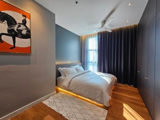 modern bedroom with artwork, double bed, and large window with curtain