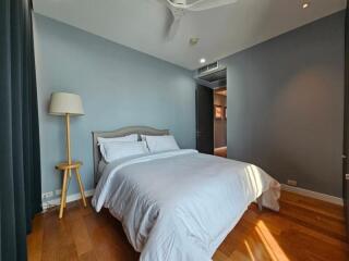 Modern bedroom with wooden flooring and natural light