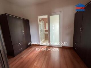 Spacious bedroom with wardrobes and a view of the bathroom