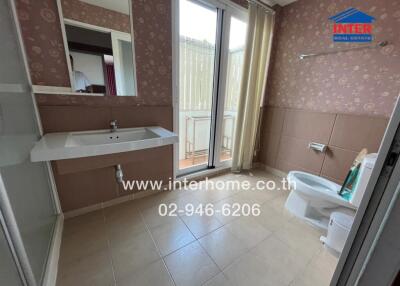 Bathroom with large mirror, sink, toilet, and shower