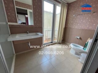 Bathroom with large mirror, sink, toilet, and shower