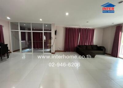spacious living room with large windows and dining area