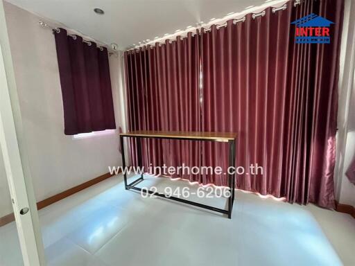 Room with curtains and a table