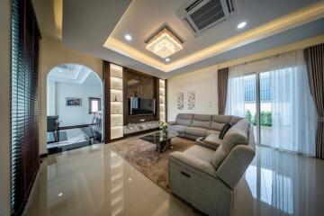 Spacious modern living room with elegant furnishings and lighting