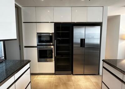 Modern kitchen with built-in appliances and large refrigerator