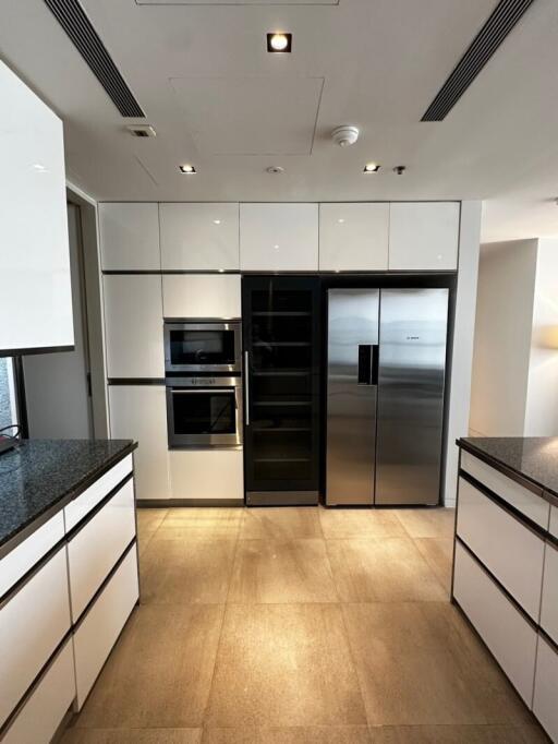 Modern kitchen with built-in appliances and large refrigerator