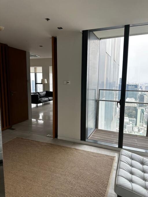 Living area with access to balcony and a view of the city skyline