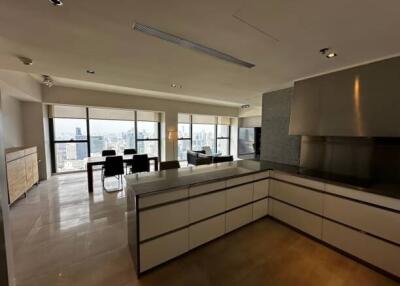 Modern open-plan kitchen and living room with large windows and city view