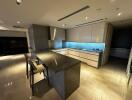 Modern kitchen with bar counter and overhead lighting