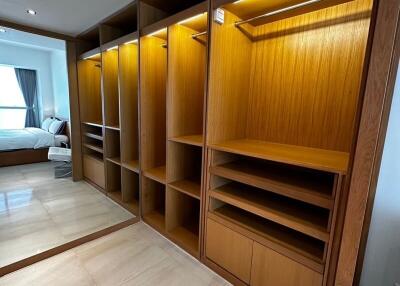 Spacious bedroom with wooden built-in wardrobe