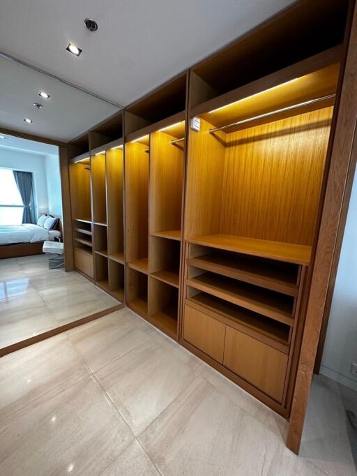 Spacious bedroom with wooden built-in wardrobe