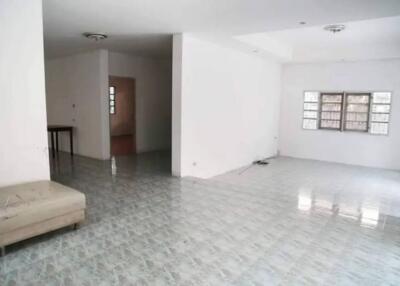 Empty main living area with tiled floor and windows