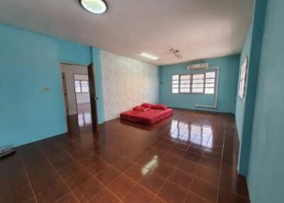 Spacious bedroom with tile flooring and minimalist decor