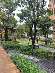 Lush garden area with walkways and playground