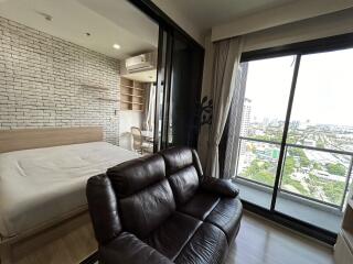 Modern bedroom with large windows and city view