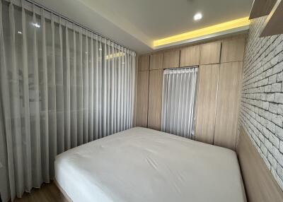 Modern bedroom with large windows and built-in wardrobes