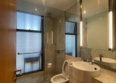 Modern bathroom with large mirrors and contemporary fixtures