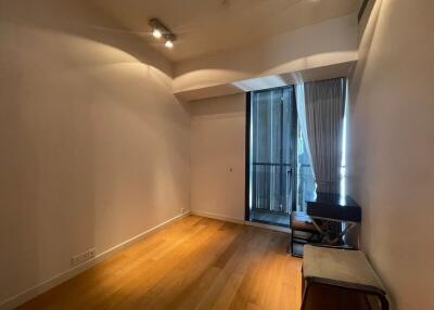 Empty living room with wooden flooring and balcony access