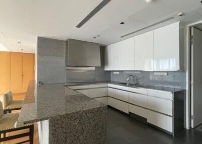 Modern kitchen with granite countertops and integrated appliances