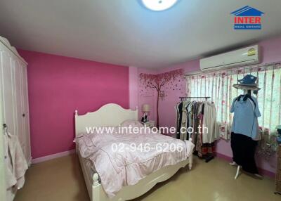 Bedroom with pink walls and white furniture